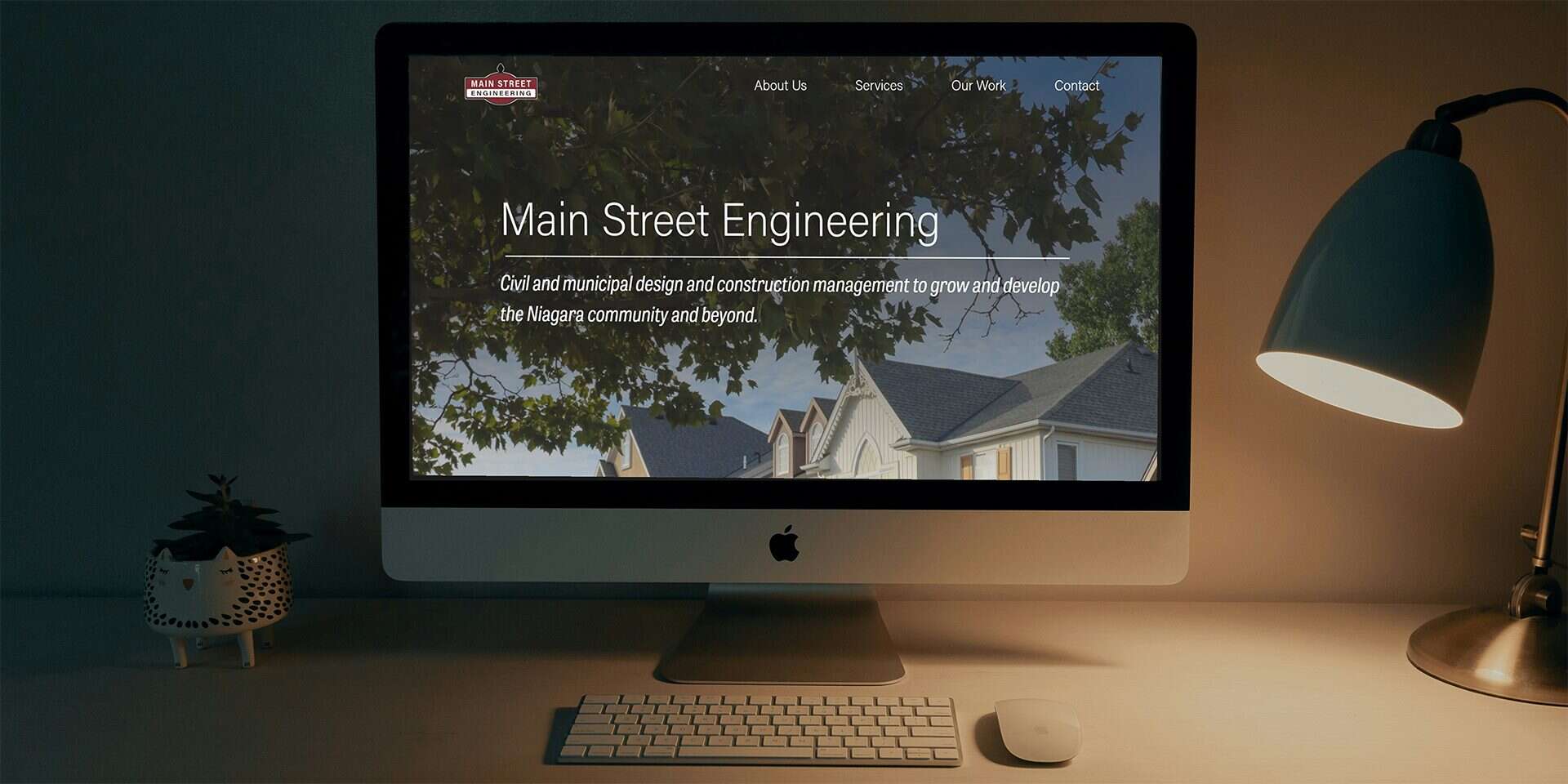 Main Street Engineering's homepage open on an iMac in a home office space.