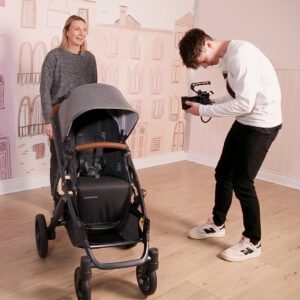 Geoffrey Faber filming someone doing a stroller review for Youtube.