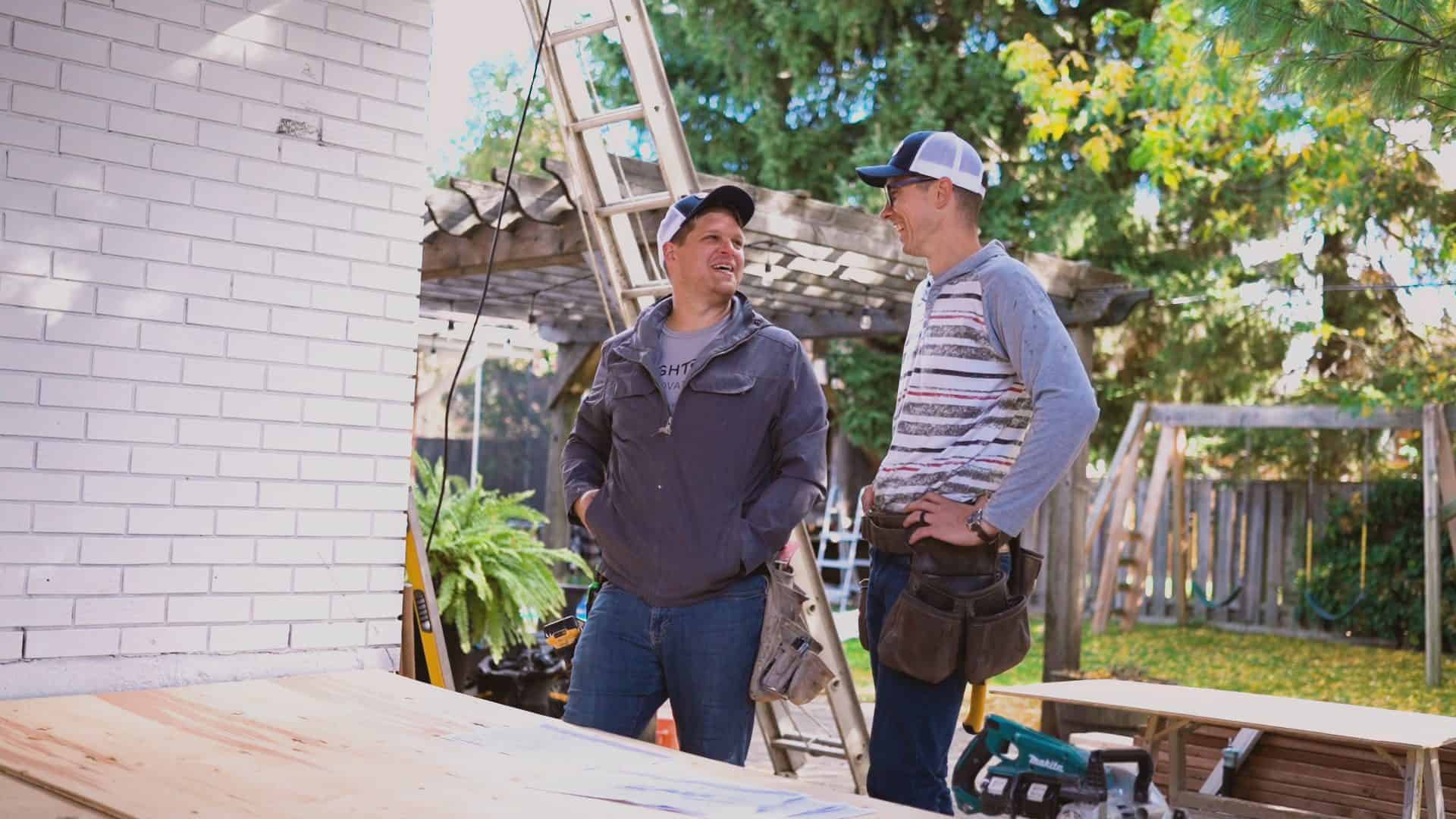 Keith Groen laughing on an outdoor construction site with Jo.